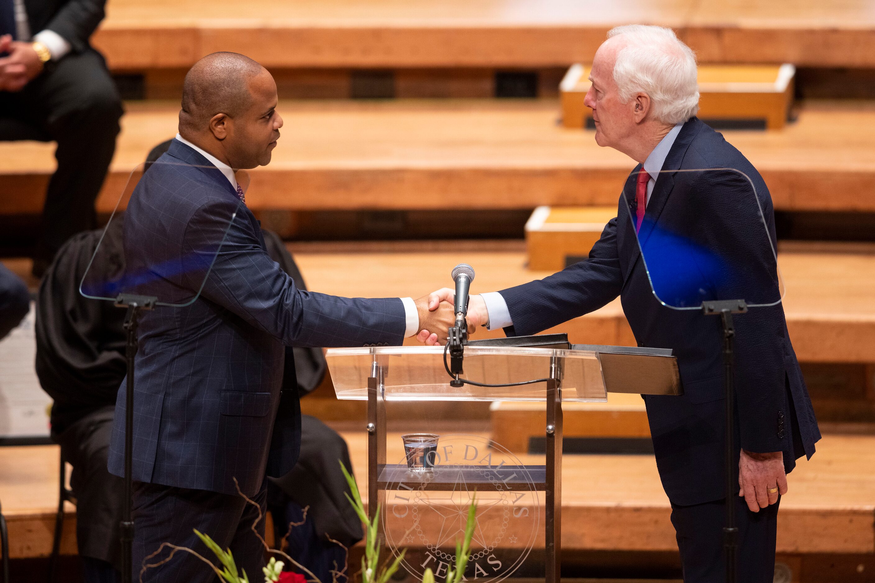 Dallas Mayor Eric Johnson shakes hands with U.S. Sen. John Cornyn after taking the oath of...