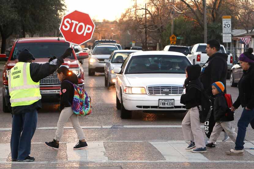Russell Roberson, 77, helped students and parents cross the street at Lorenzo De Zavala...