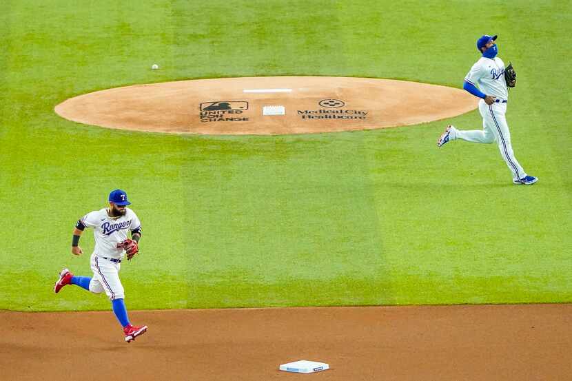 Rangers second baseman Rougned Odor (left) and shortstop Elvis Andrus take the field to face...