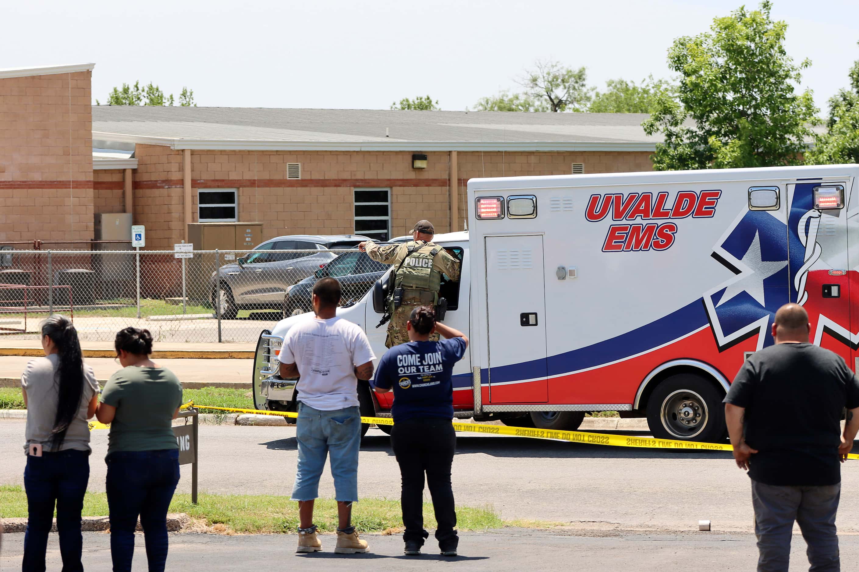 Law enforcement officers direct an ambulance in a photo by Pete Luna, General manager,...