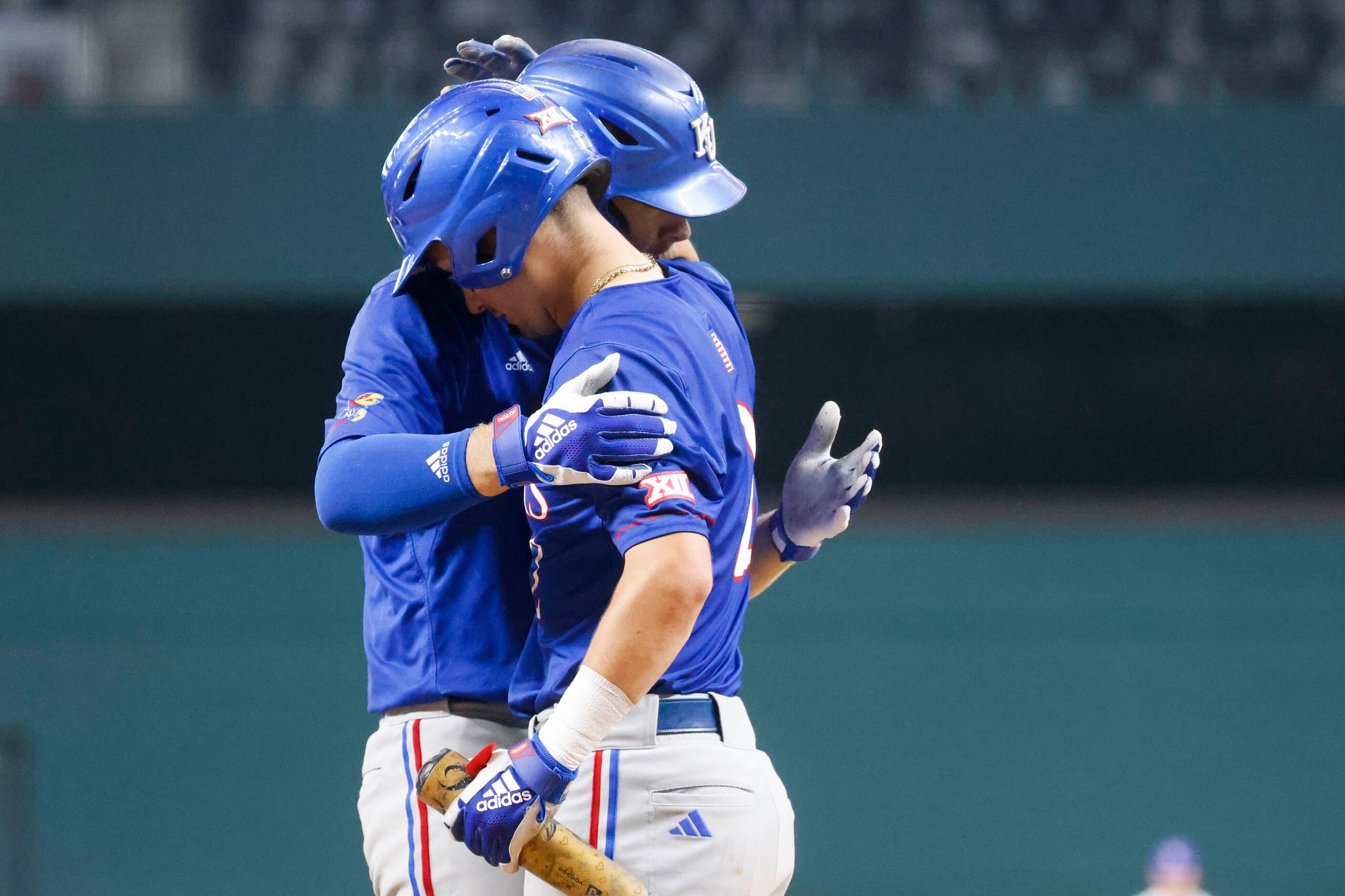 Kansas catcher Jake English (left) embrace outfielder Mike Koszewski after a homer by...