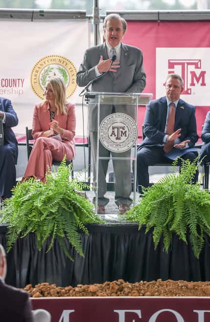 The crowd and officials behind John Sharp (center), chancellor of Texas A&M University...