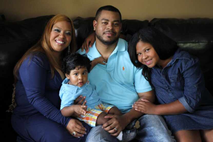 Barry Wallace of Dallas, with wife Lorrie, daughter Thalia, 10, and son Iverson, 9 months,...