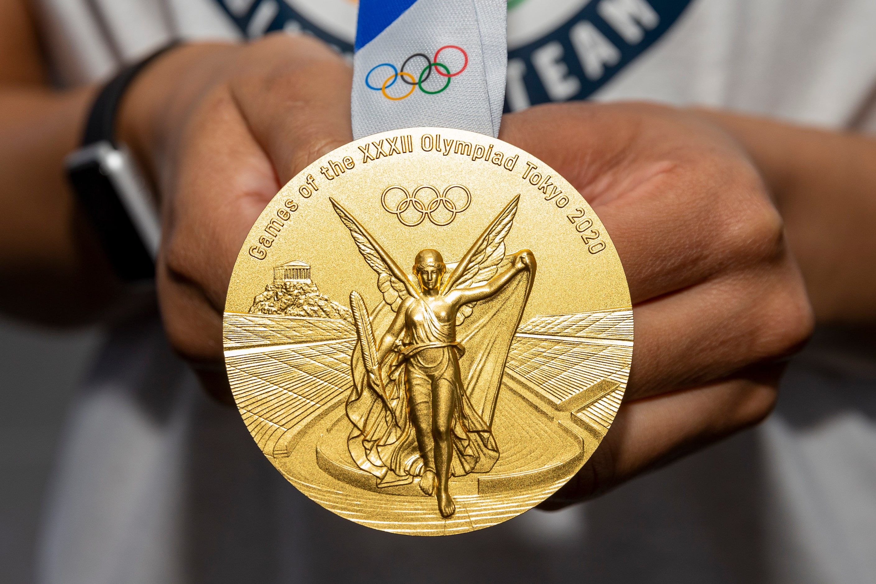 Allisha Gray, Olympic gold medalist and Dallas Wings guard, displays her gold medal during a...