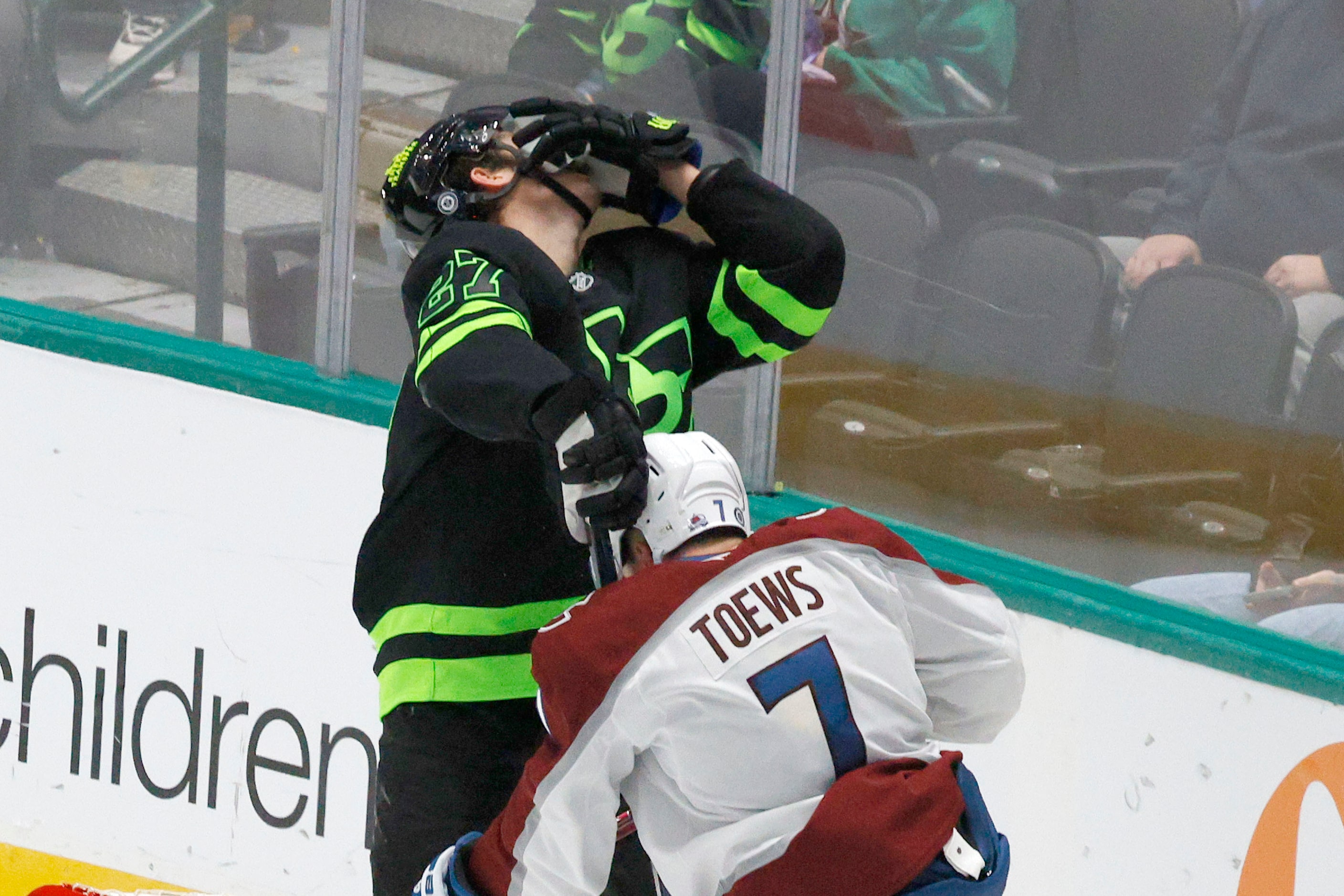 Dallas Stars left wing Mason Marchment (27) is hit by Colorado Avalanche defenseman Devon...