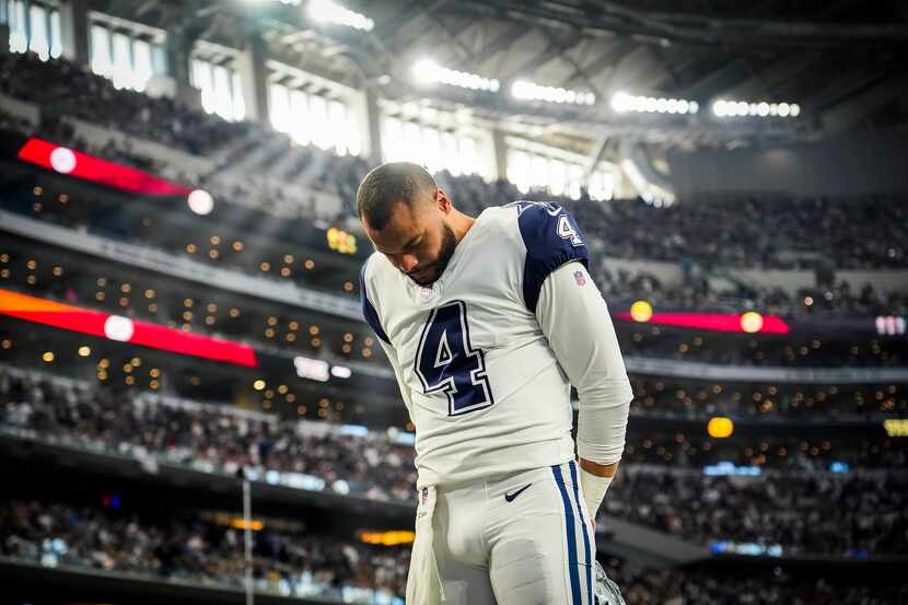 Dallas Cowboys quarterback Dak Prescott (4) stands on the field before an NFL football game...