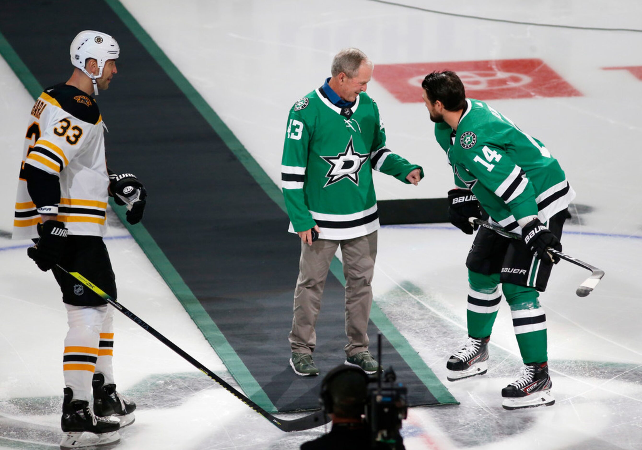 Former President George W. Bush attempts to fist bump Dallas Stars left wing Jamie Benn (14)...