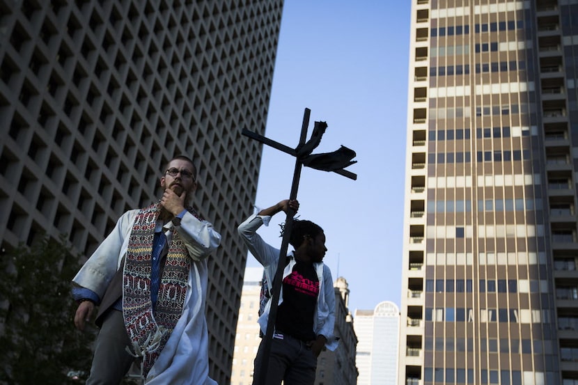 Organizer Rev. Jeff Hood (left) and Christian Parks wait in Belo Garden to begin a Black...