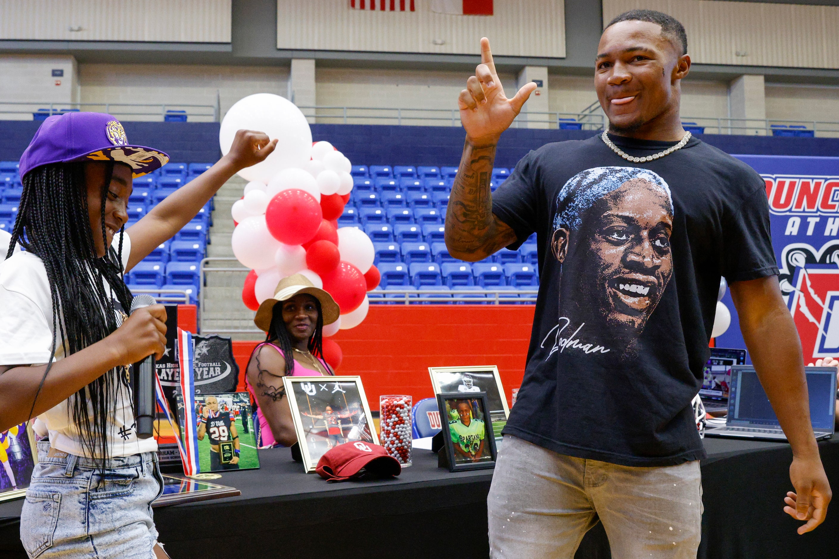 Duncanville running back Caden Durham holds up an “L” after choosing LSU as his sister...