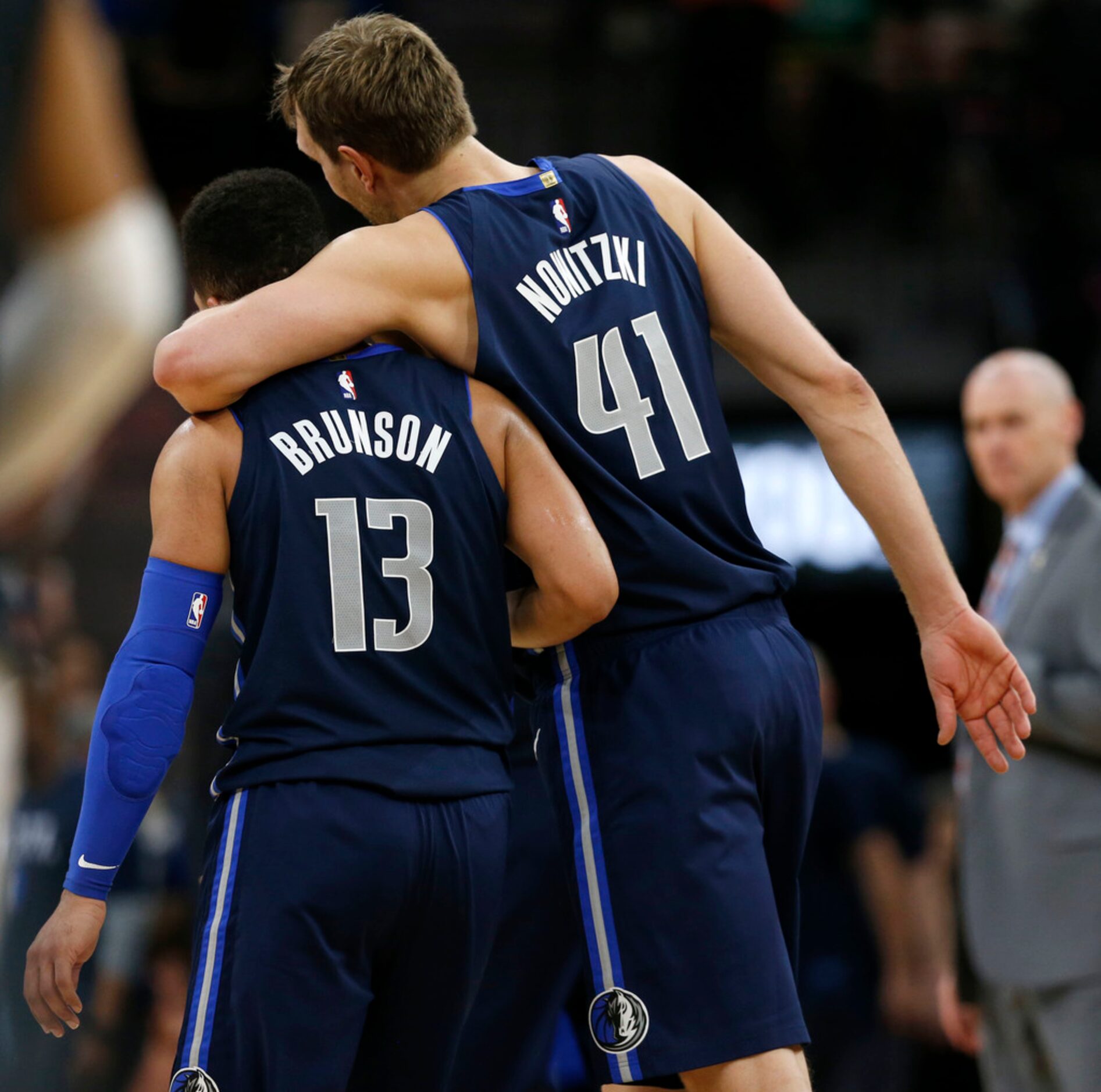 Dallas Mavericks forward Dirk Nowitzki (41) hugs teammate Jalen Brunson (13) during the...