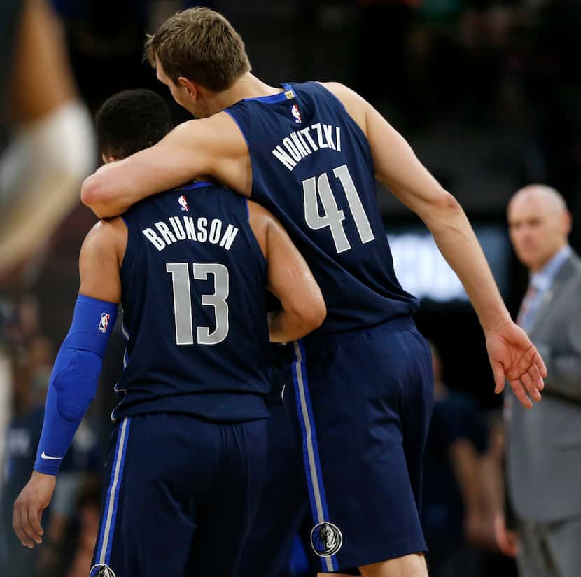 Dallas Mavericks forward Dirk Nowitzki (41) hugs teammate Jalen Brunson (13) during the...