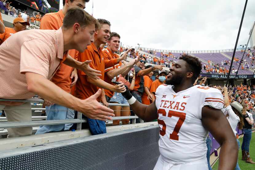 Texas Longhorns offensive lineman Tope Imade (67) greets fans after the win as the TCU...