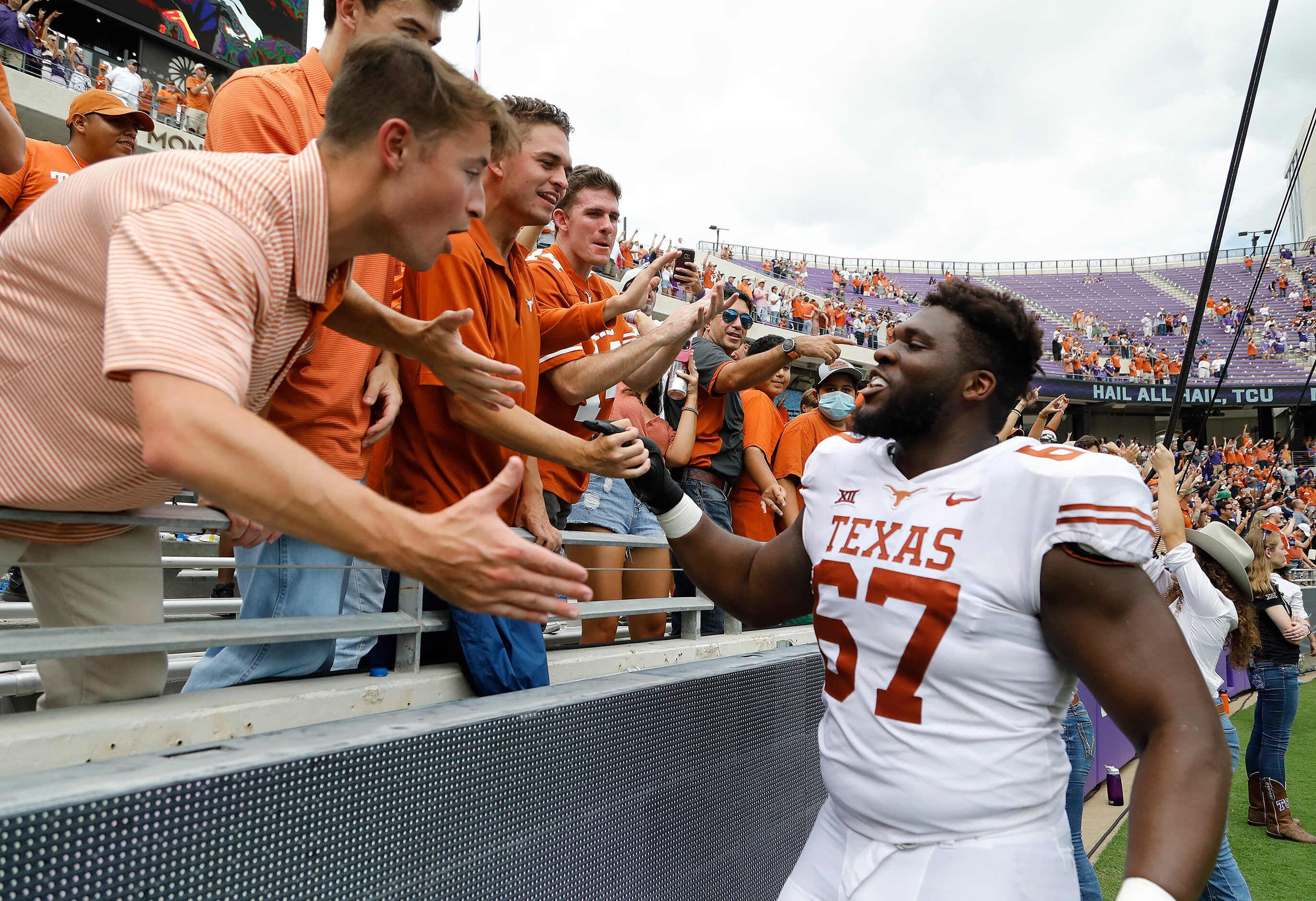 Texas Longhorns offensive lineman Tope Imade (67) greets fans after the win as the TCU...