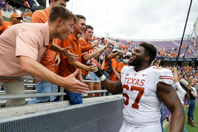Texas Longhorns offensive lineman Tope Imade (67) greets fans after the win as the TCU...