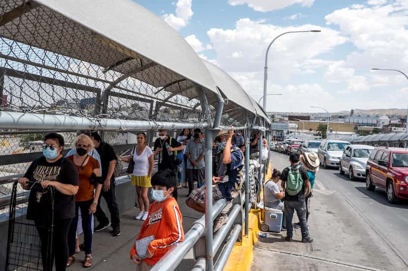 People wait in line to cross the border to El Paso, Texas, through the Paso Del Norte Port...