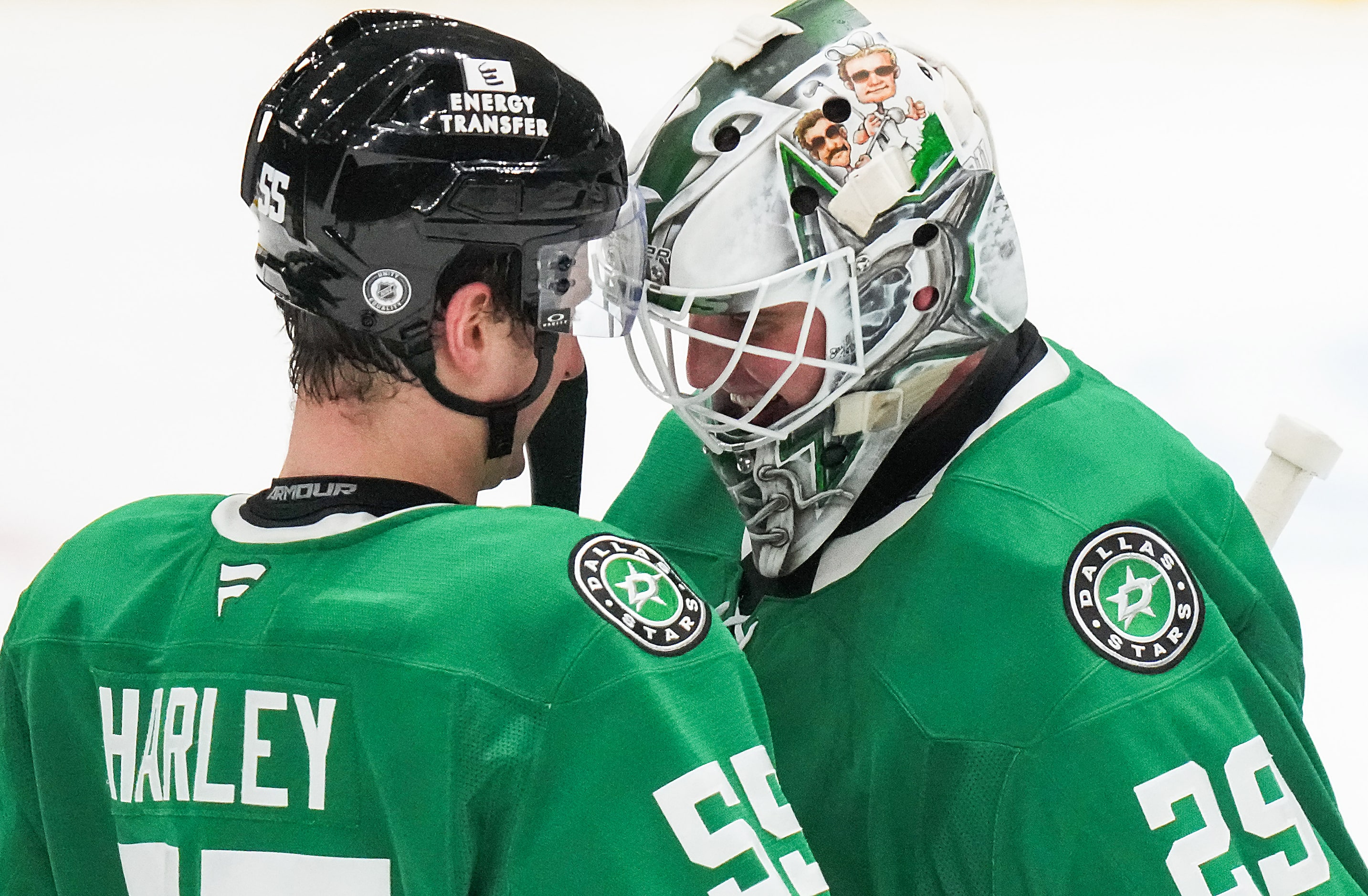 Dallas Stars goaltender Jake Oettinger (29) celebrates with defenseman Thomas Harley (55)...