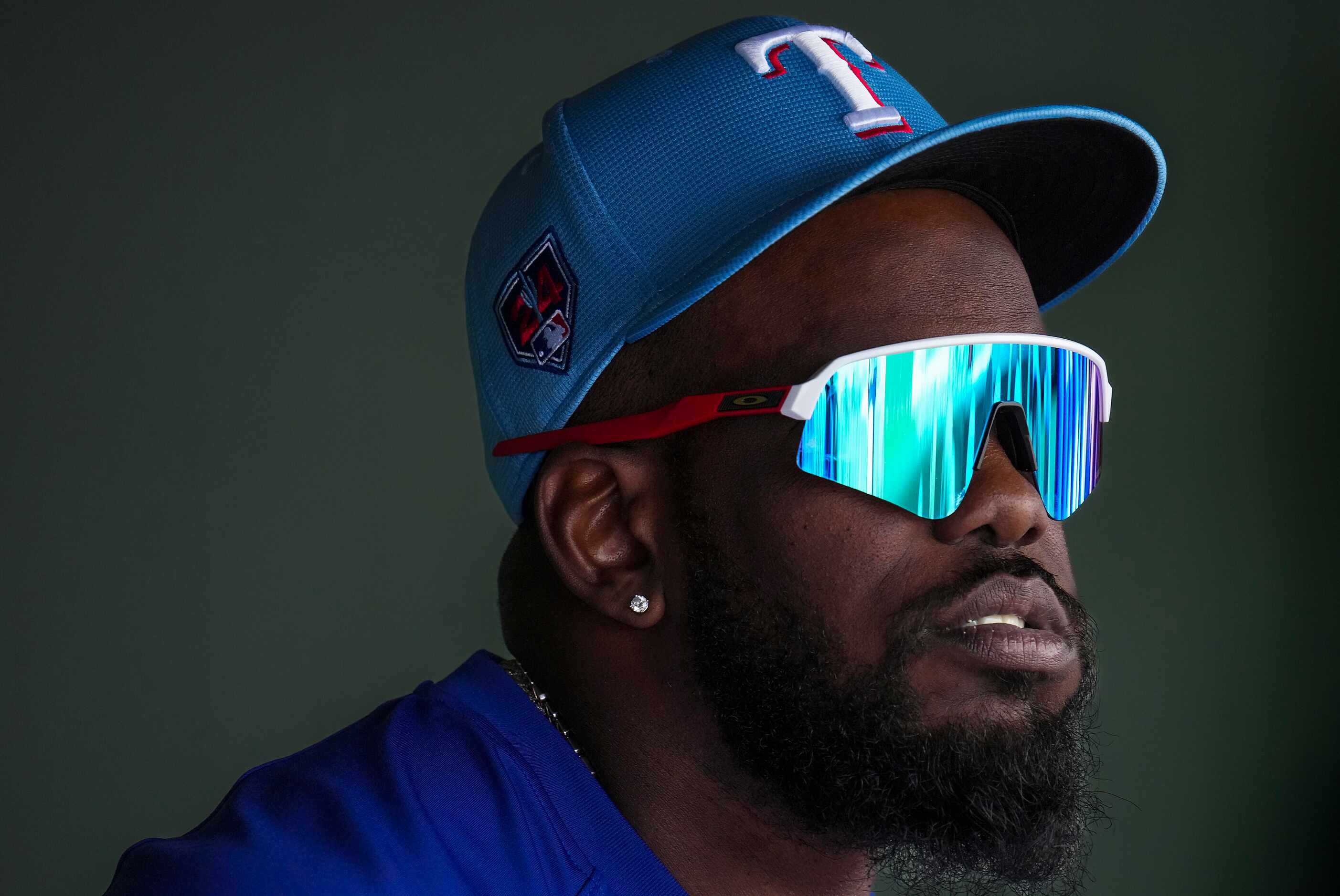 Texas Rangers outfielder Adolis García looks out from the dugout during the first inning of...