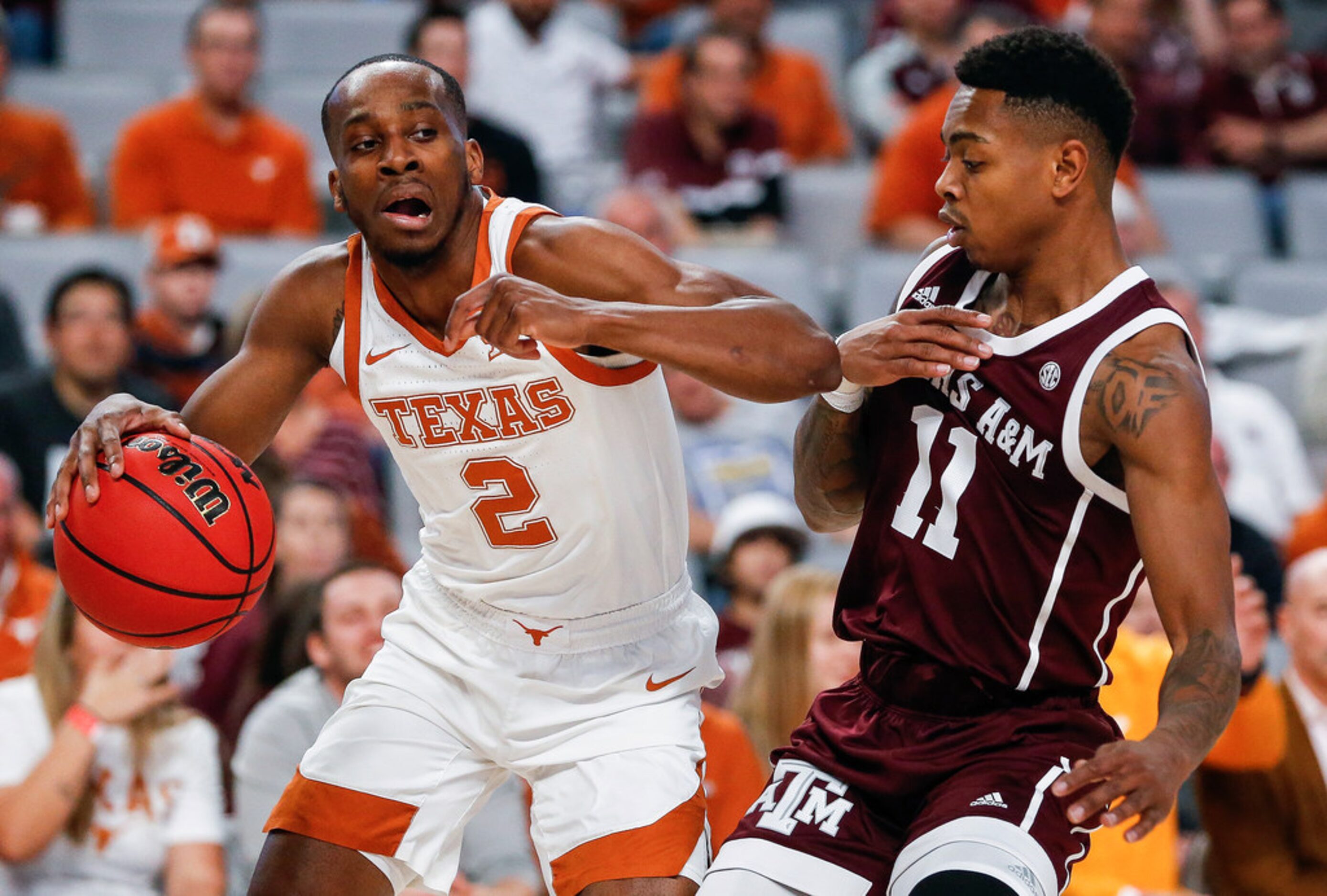 Texas Longhorns guard Matt Coleman III (2) drives past Texas A&M Aggies guard Wendell...