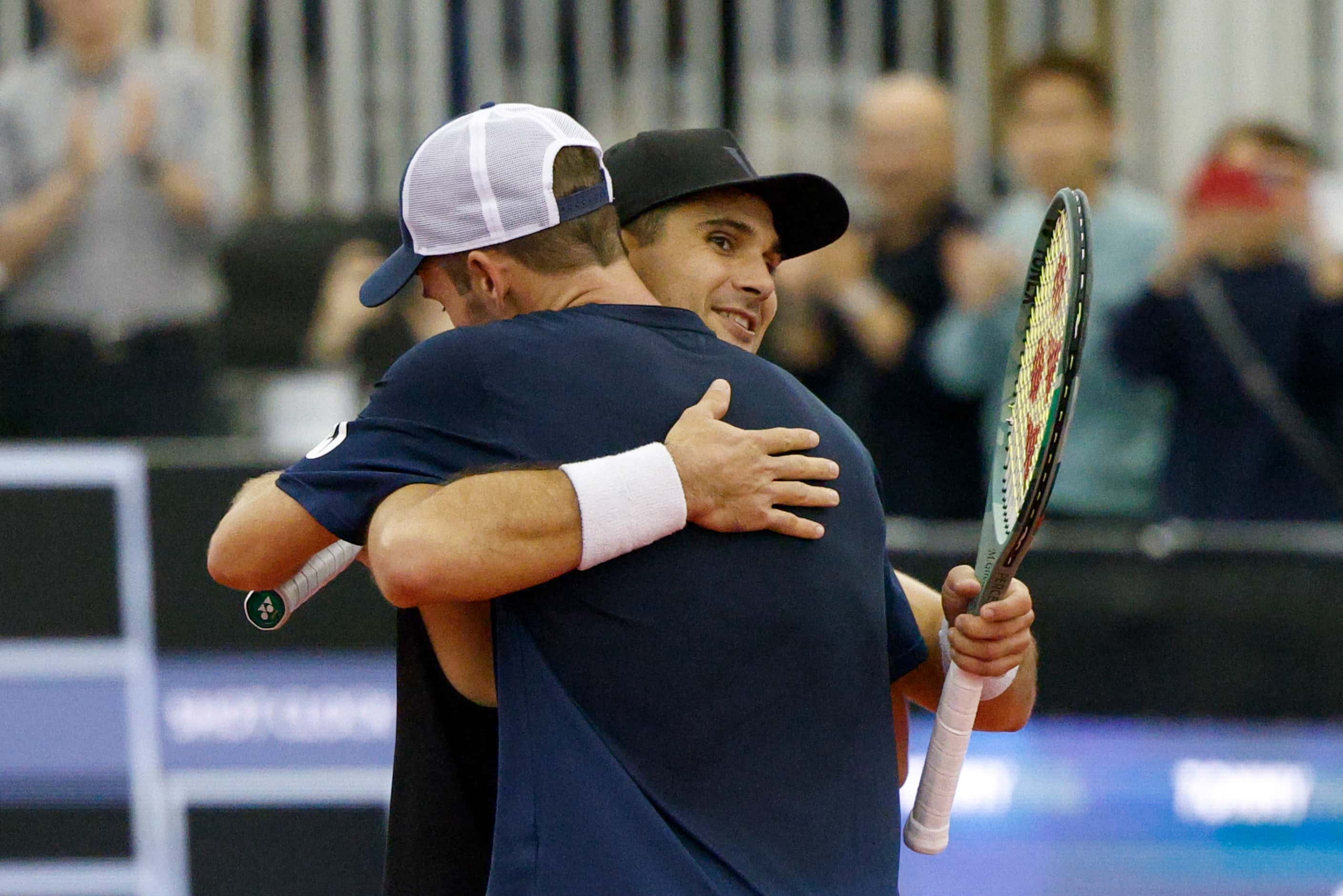 Tommy Paul of the U.S. (front) hugs Marcos Giron of the U.S. after winning the ATP Dallas...