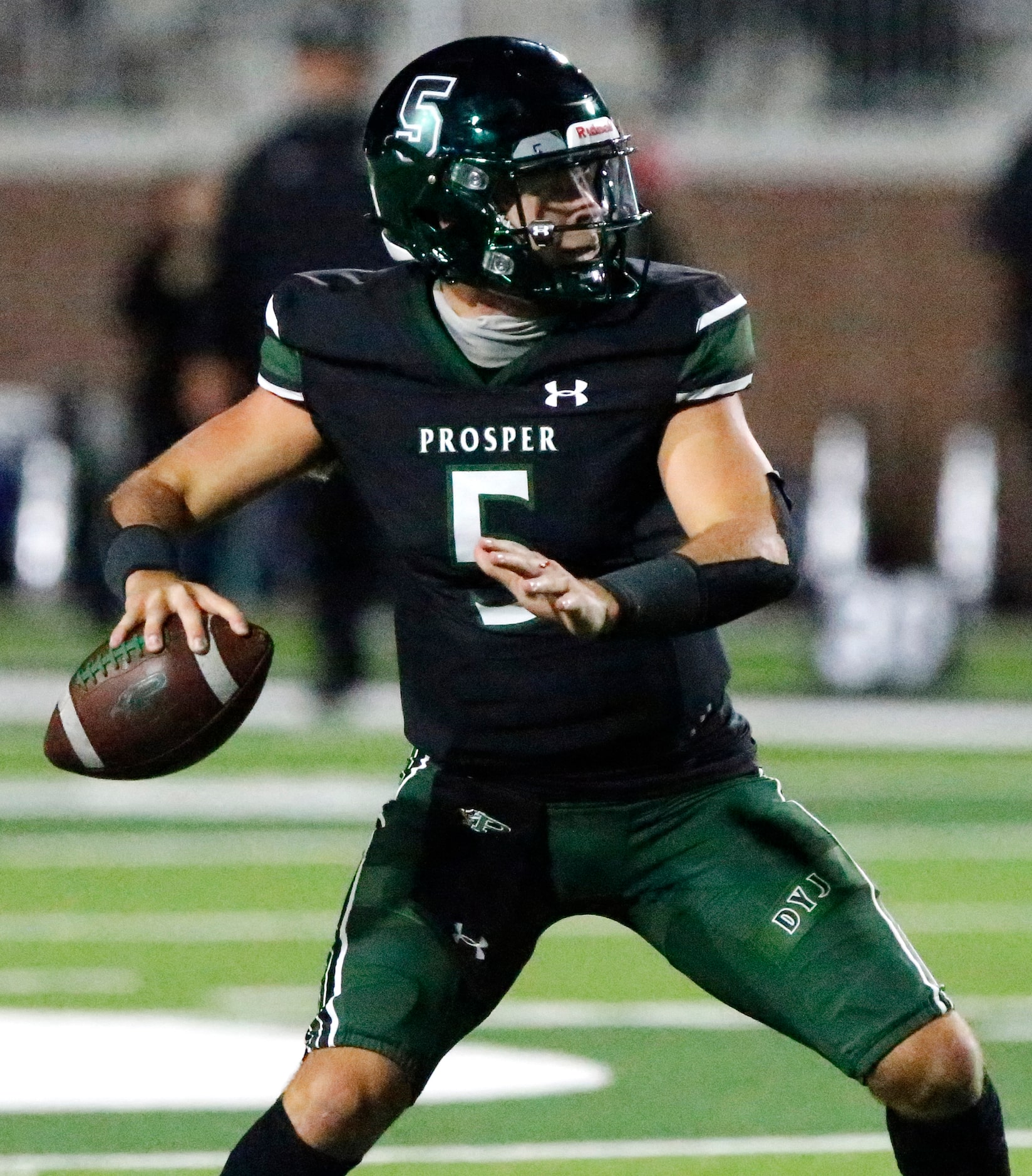 Prosper High School quarterback Jackson Berry (5) throws a touchdown pass during the first...