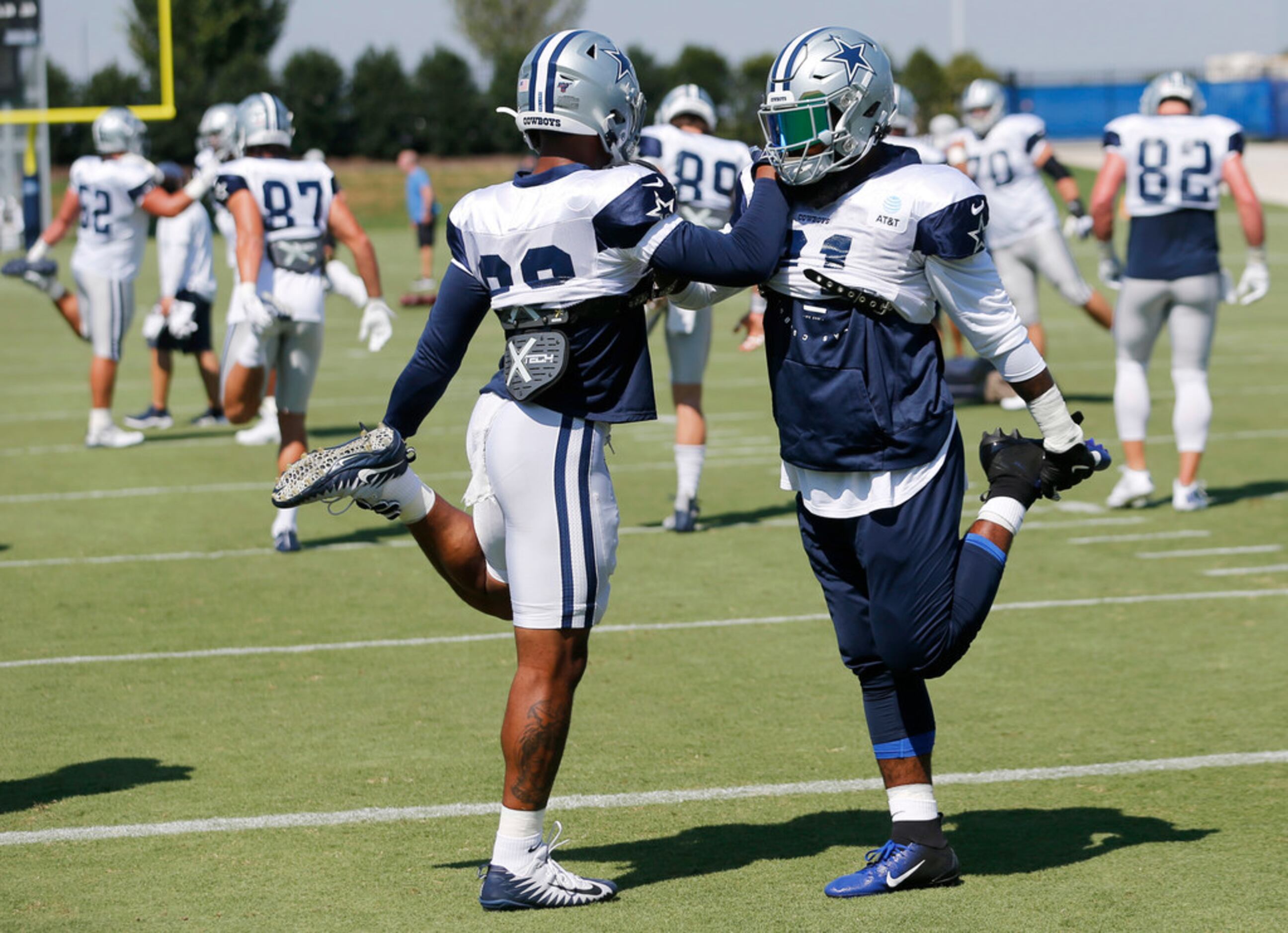Dallas Cowboys running back Tony Pollard (20) stretches with Dallas Cowboys running back...