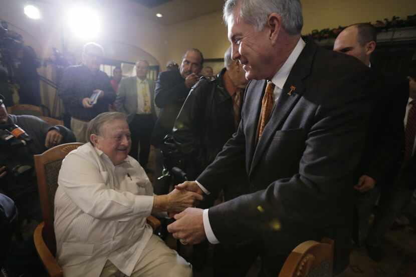 Texas coach Mack Brown, right, reaches out to long-time Texas booster Red McCombs, left,...