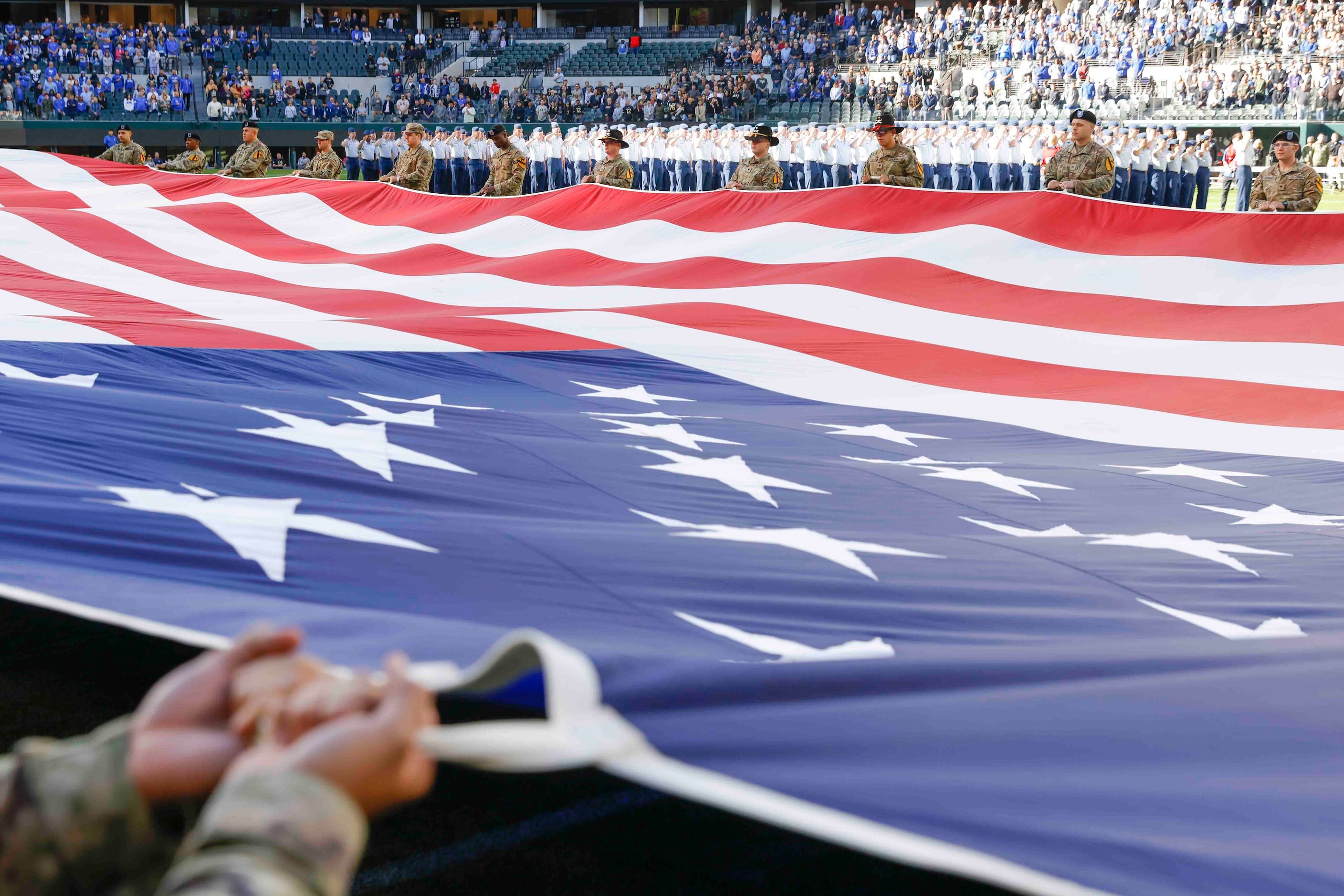 Army cadets display the National flag ahead of an NCAA football game against Air Force at...