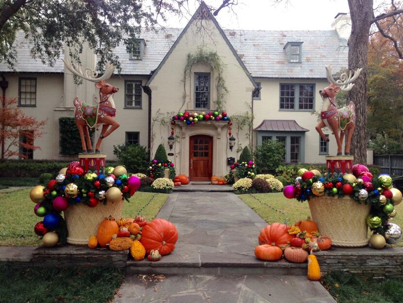 A mix of colorful, oversized ornaments spill over the sides of two large planters and...