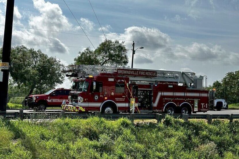 Emergency personnel work at the site of a fatal vehicular collision at a bus stop in...