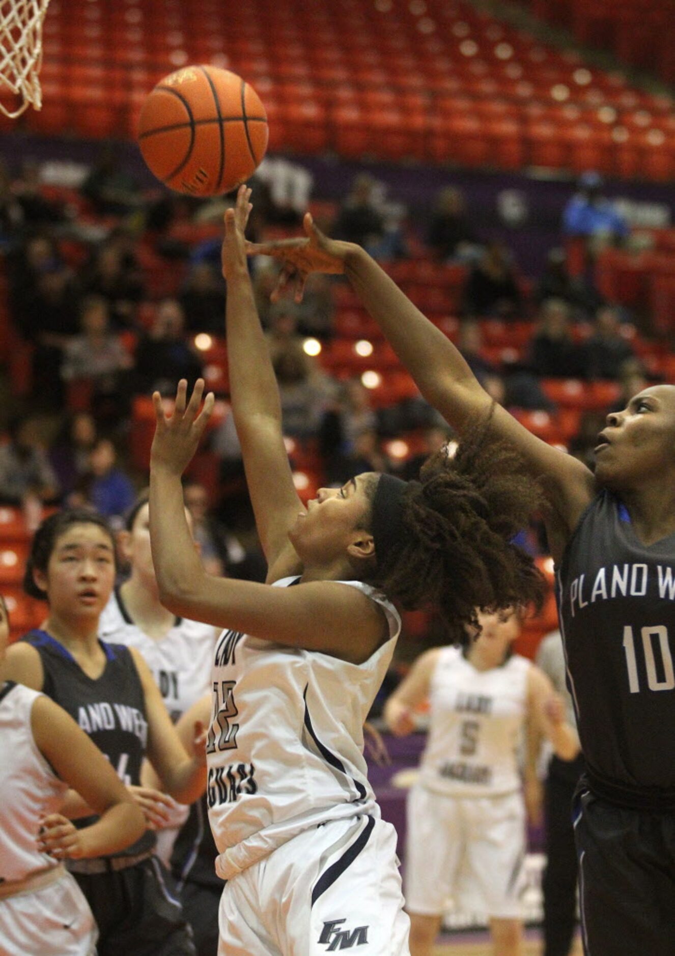 Flower Mound High School senior Courtney Fields (12) puts up a shot against Plano West...