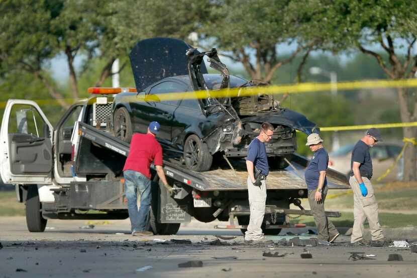 
Members of the FBI evidence response team took a last look after the attackers’ damaged car...