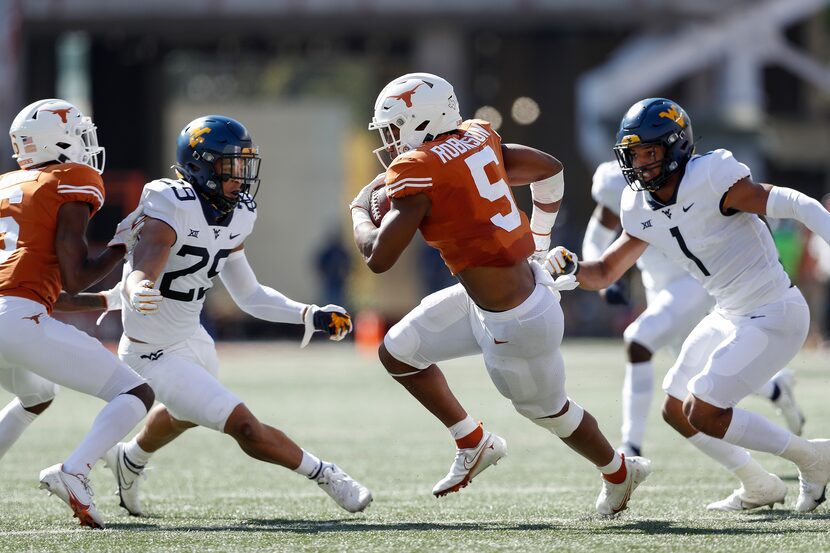 AUSTIN, TEXAS - NOVEMBER 07: Bijan Robinson #5 of the Texas Longhorns carries the ball...