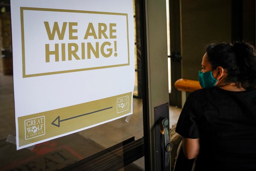 A sign directs job candidates to a hiring event at Great Wolf Lodge Grapevine on Tuesday,...