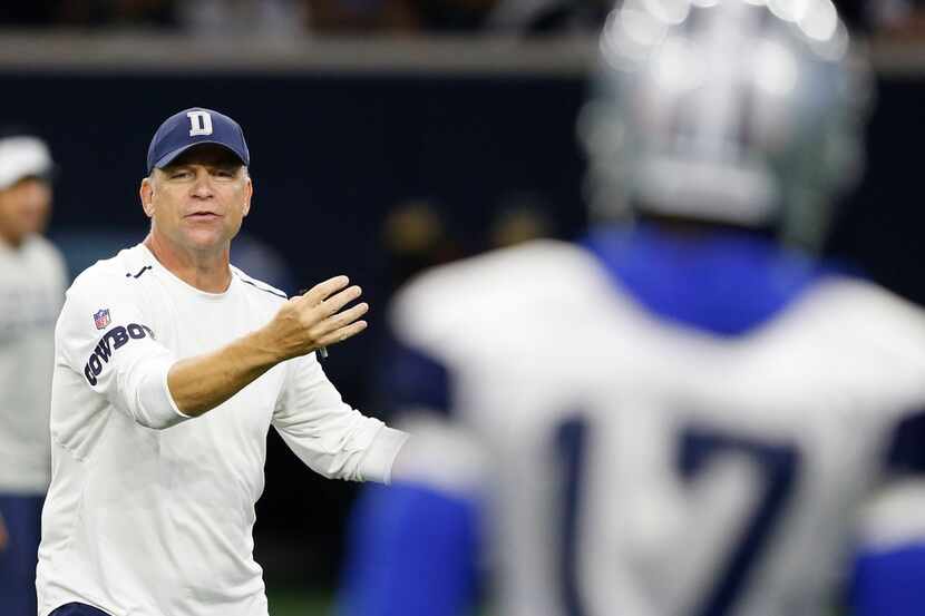 FILE - Cowboys offensive coordinator Scott Linehan coaches wide receiver Allen Hurns (17)...
