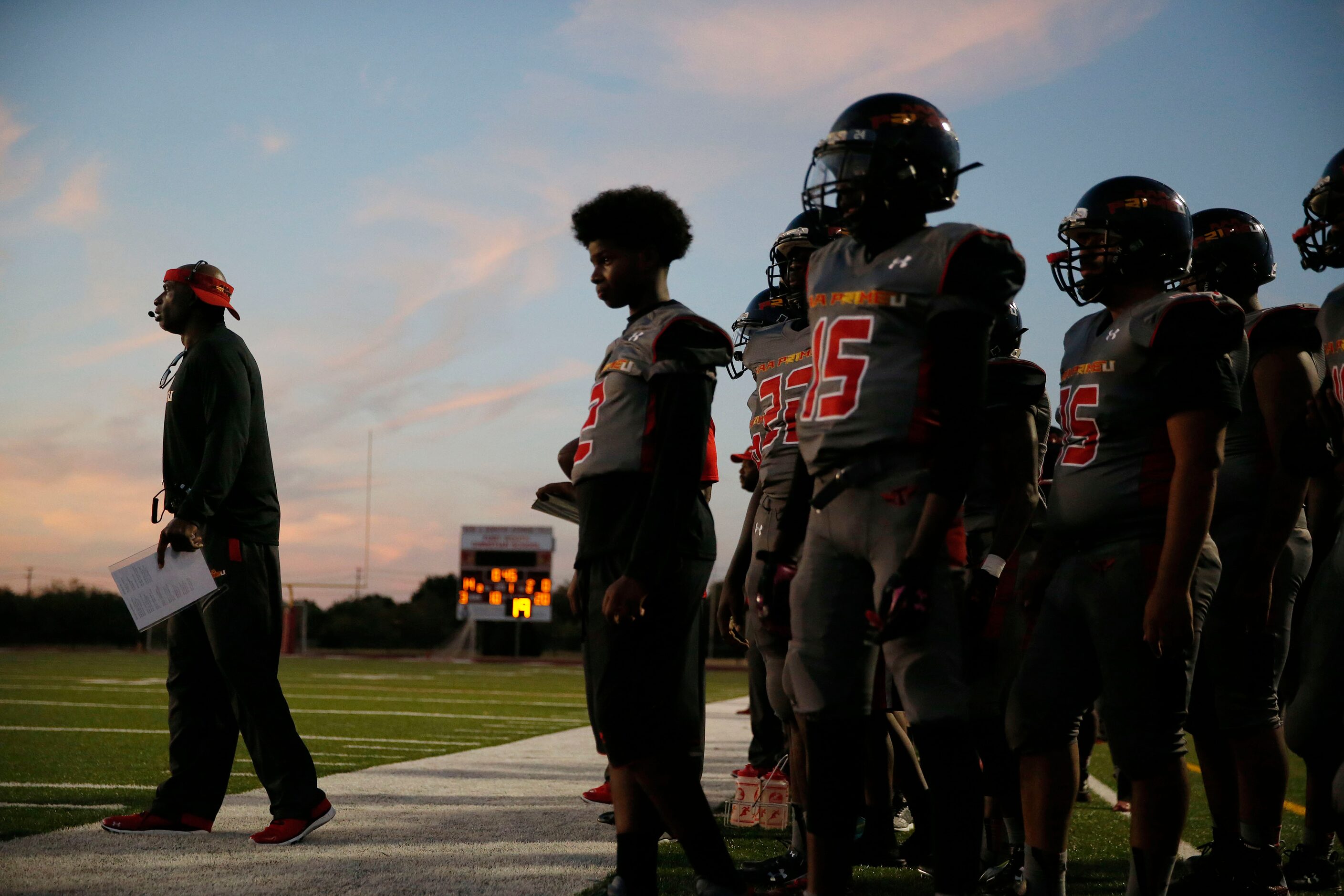 AAA Prime U coach Deion Sanders (left) walks the sideline in the first half during a high...