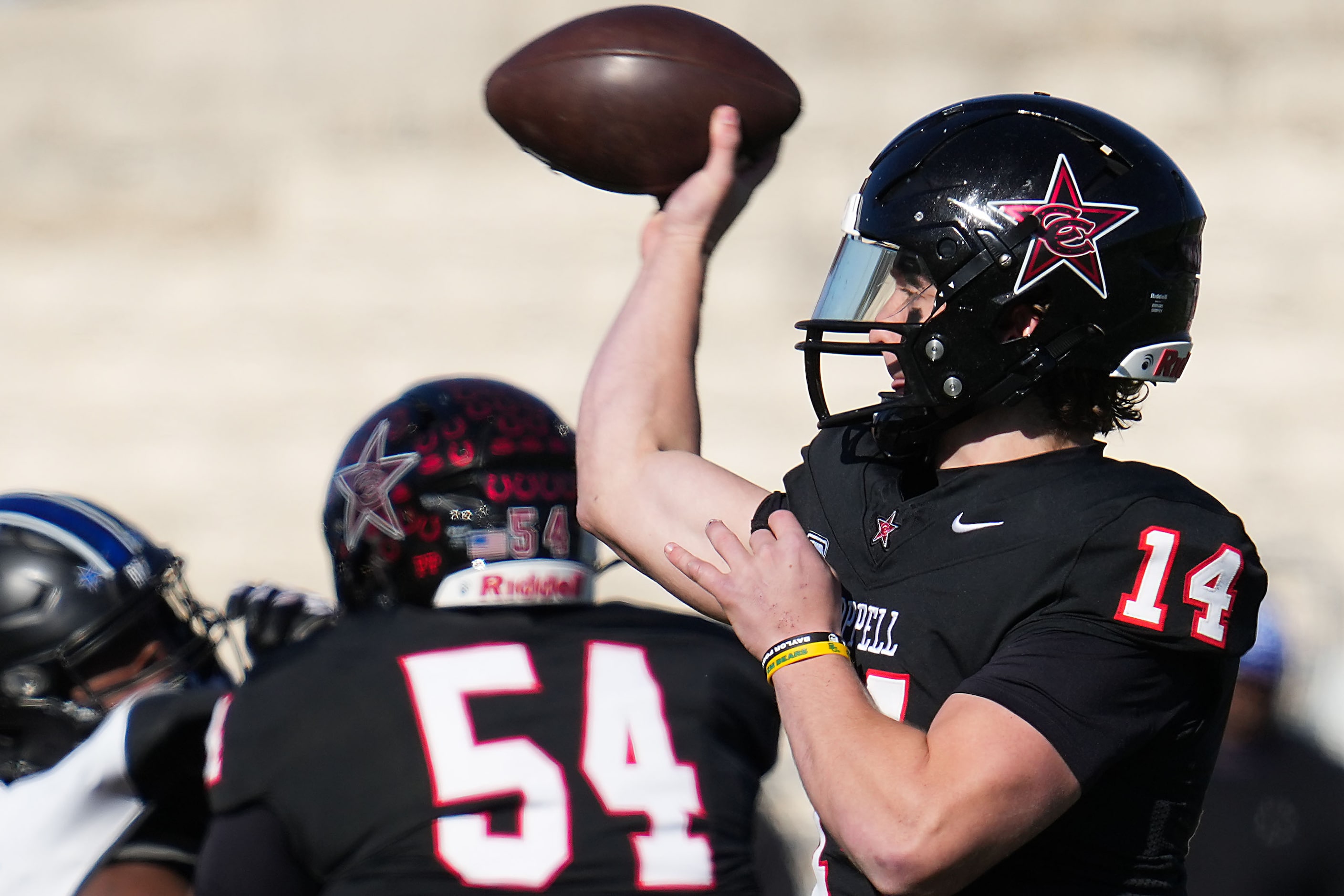 Coppell quarterback Edward Griffin (14) throws a pass during the first half of a UIL Class...