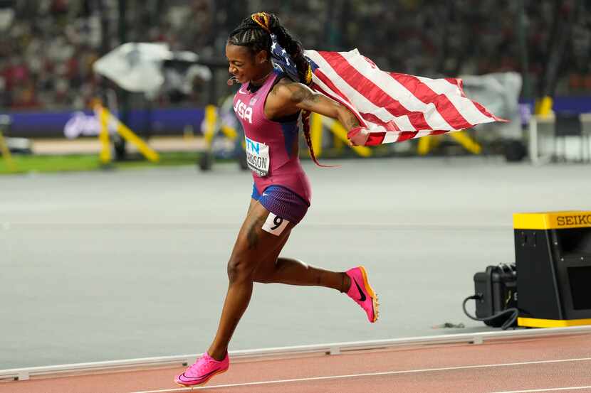 Sha'Carri Richardson of Dallas celebrates winning the women's 100 meters during the World...