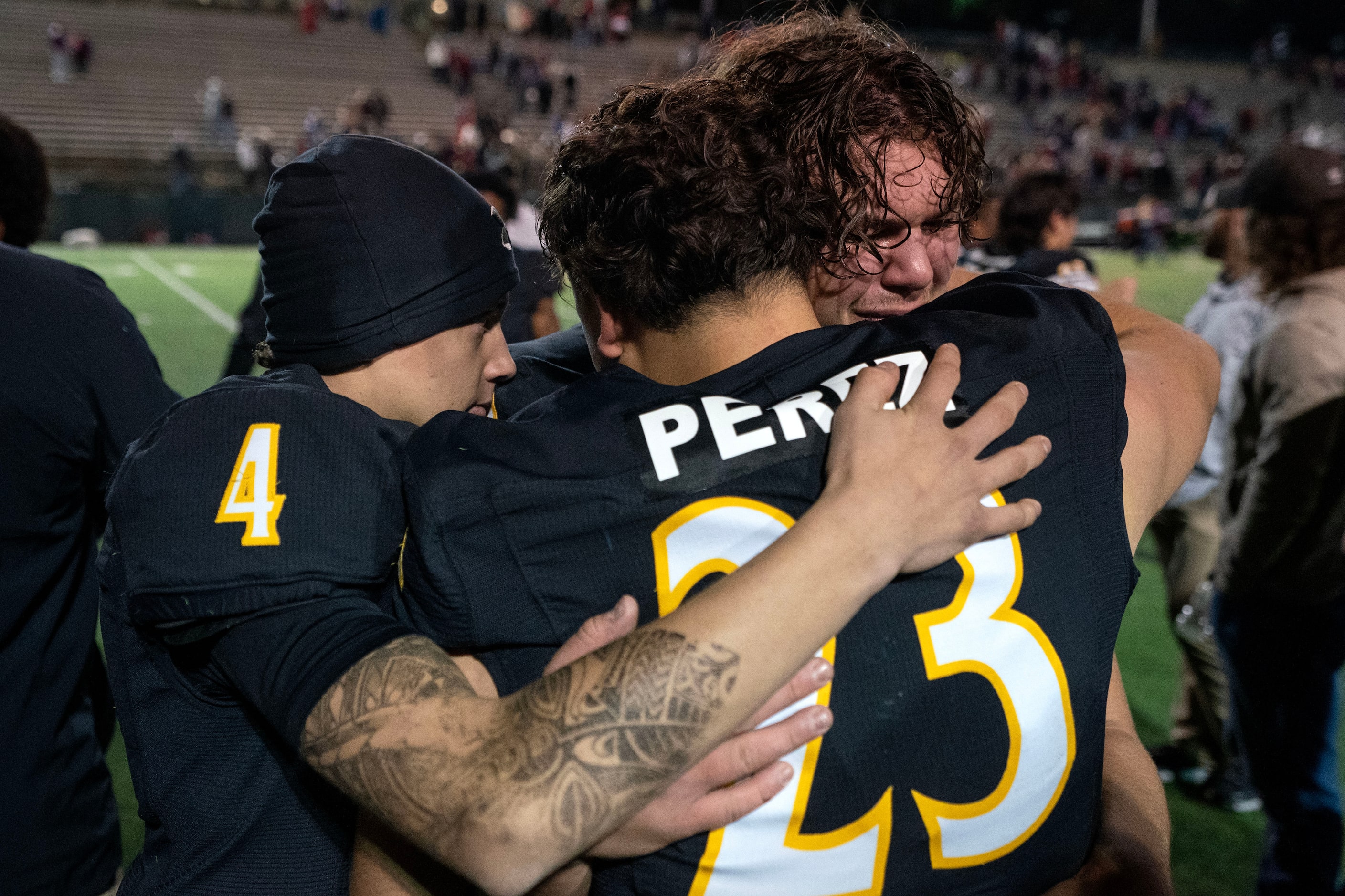 Crandall sophomore defensive end Hudson West (40) is comforted by senior kicker Brandon...