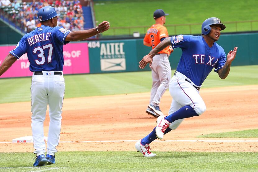 ARLINGTON, TX - JULY 14: Shawn Kelley #27 of the Texas Rangers waves in Willie Calhoun #5 to...