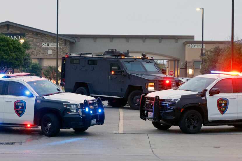 Law enforcement including Plano Police secure the scene after a mass shooting at the Allen...