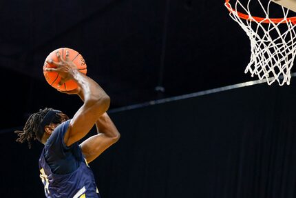 McKinney guard Alex Anamekwe (14) dunks the ball as time expires in double overtime to win...