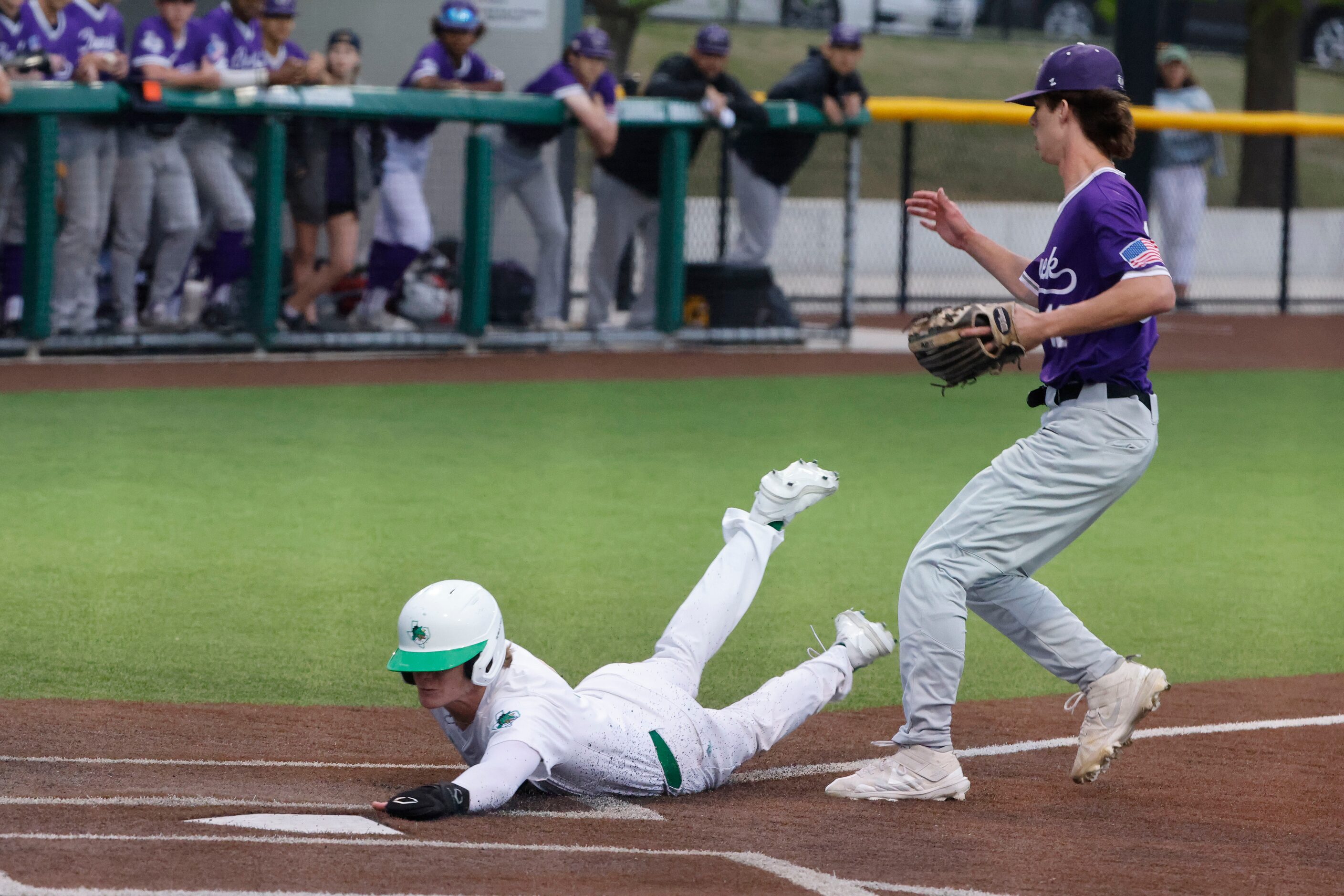 Southlake’s Tyson Drake scores on a wild pitch as as Keller Timber Creek pitcher Tanner...