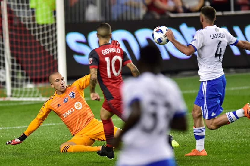 Toronto FC forward Sebastian Giovinco (10) chips the ball over Montreal Impact goalkeeper...