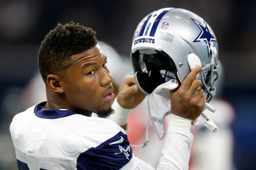 Dallas Cowboys wide receiver Terrance Williams (83) prepares to put his helmet on during...
