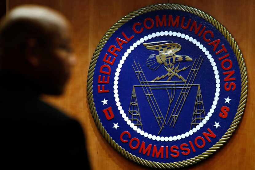 FILE- This Dec. 14, 2017, file photo, shows the seal of the Federal Communications...