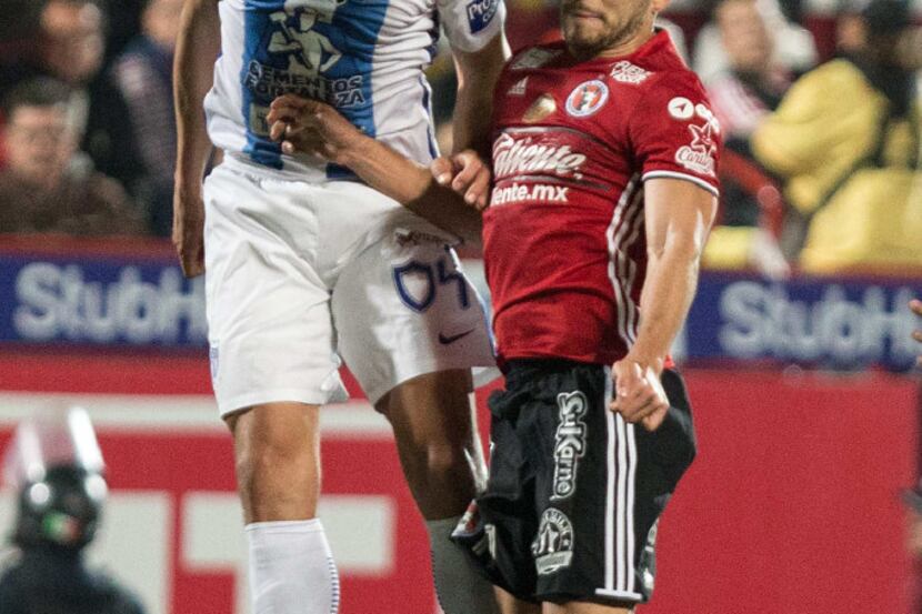 Pachuca's defender Omar Gonzalez (L) vies for the ball with Tijuana's Henri Martin (R)...