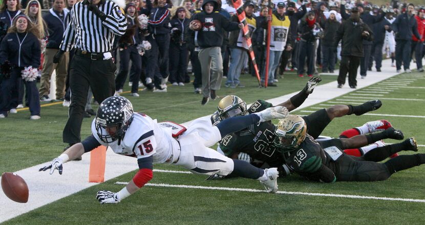 Allen Eagles wide receiver Josh Pettijohn (15) loses the ball after being hit by...