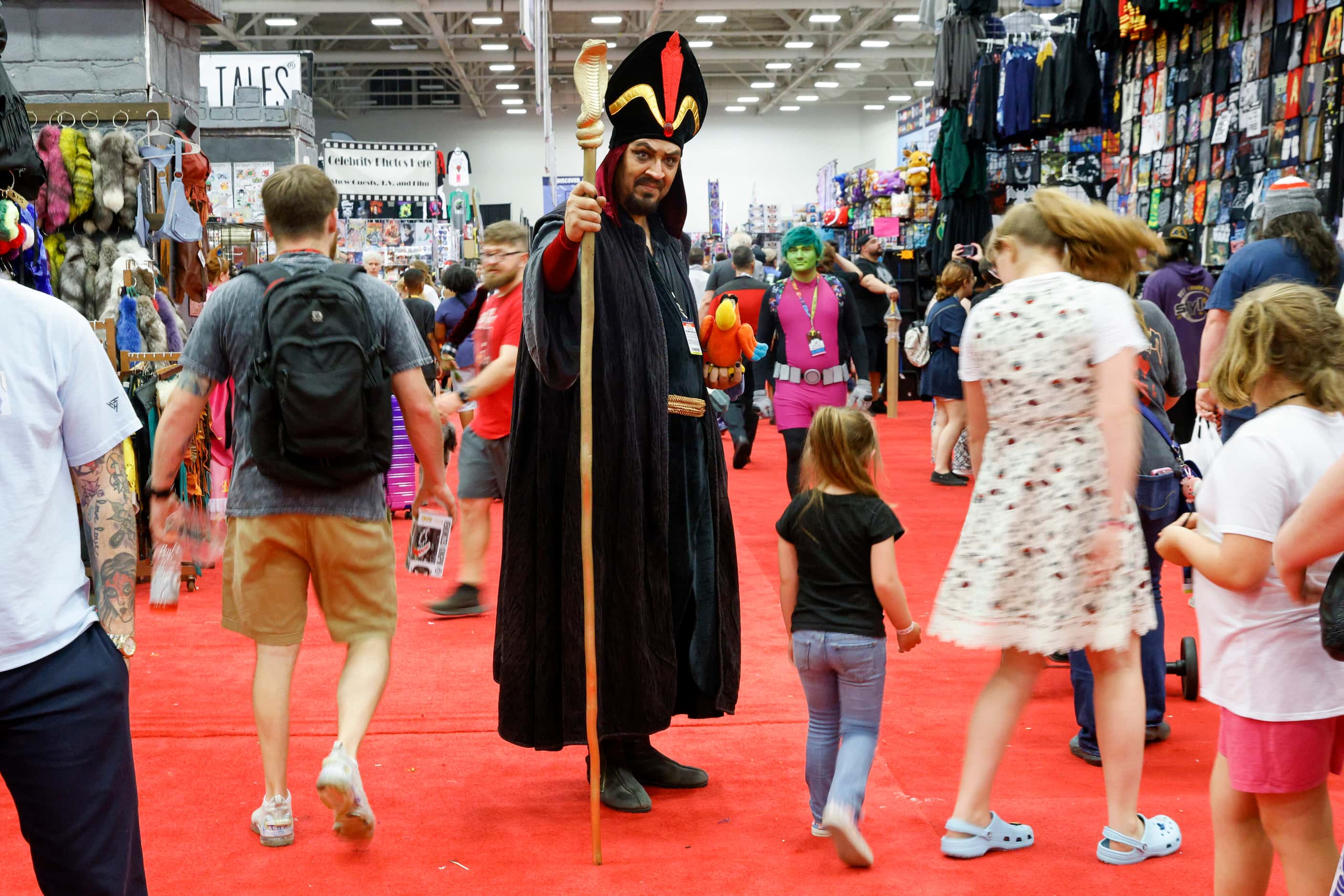 Cliff Camacho (center) stands outside his store dressed as Jafar from Aladdin at Fan Expo...
