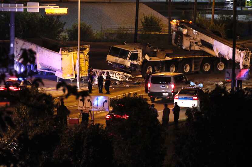 A crane and a truck sit damaged after a collision at Linfield Rd and 310/S Central Expy on...