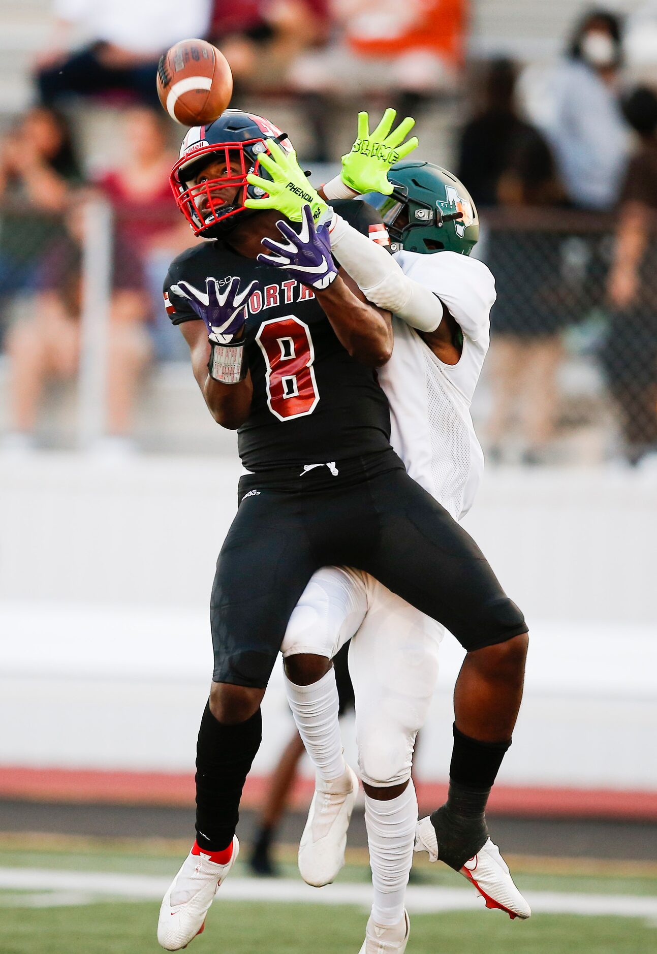 Garland Naaman Forest senior defensive back Roman Williams, background, breaks up a pass...